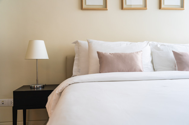 white-comfortable-pillow-bed-decoration-interior_74190-9524
